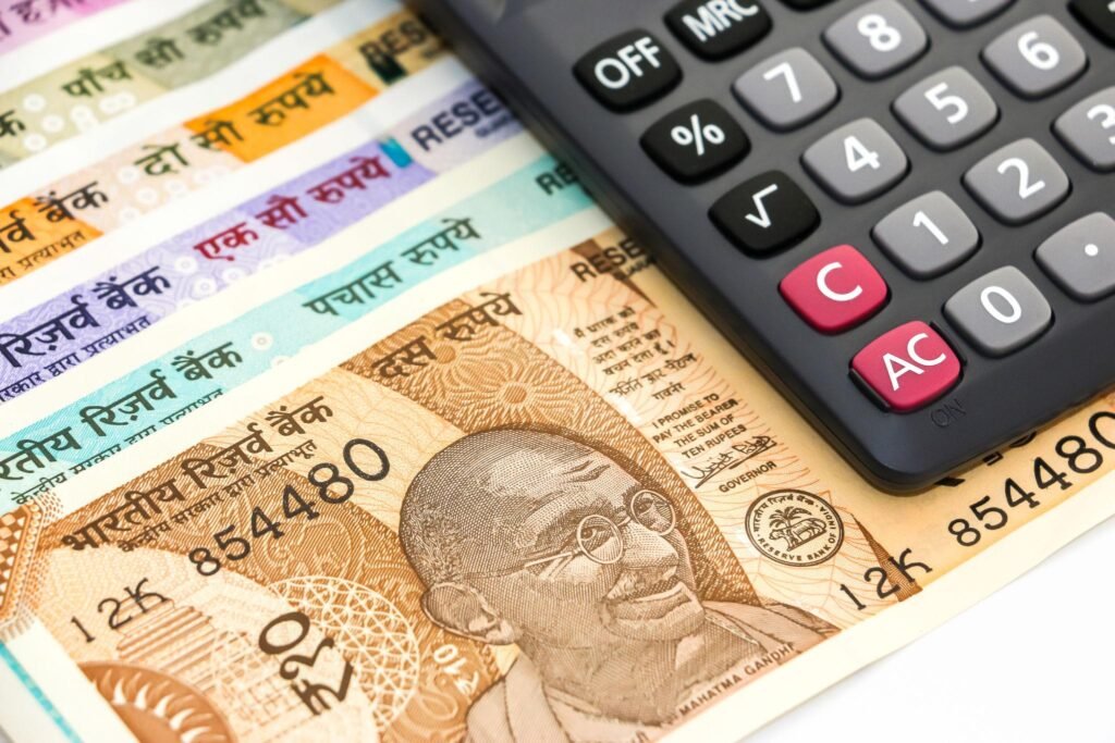 Calculator placed on Indian rupee notes representing succession certificate cost, court fees, and legal expenses in India
